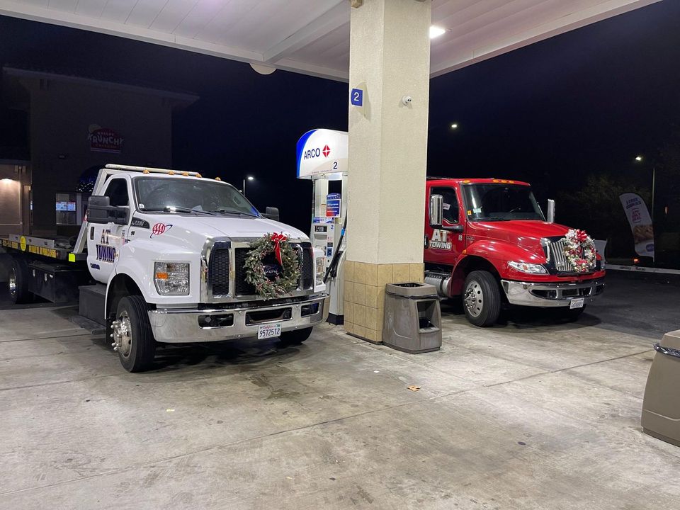 AT Towing flatbed carrying a commercial vehicle