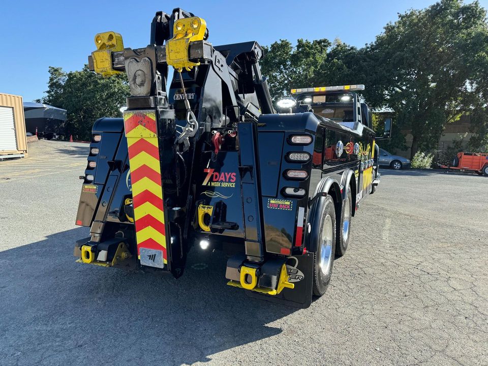 Rear view of the AT Towing heavy recovery unit with the boom stowed