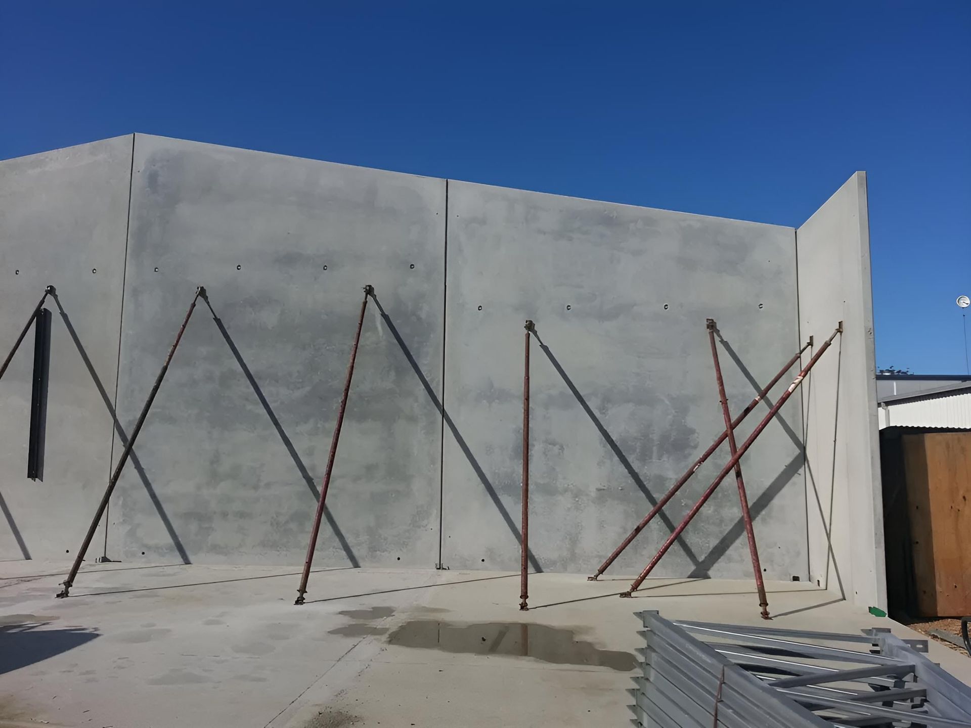A Concrete Wall With Scaffolding on It  — Aspex Construction - Lou Pieren In Port Macquarie, NSW