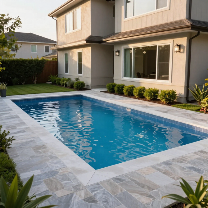 Modern backyard with a blue swimming pool beside a beige two-story house and patio windows
