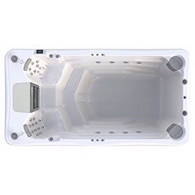 Overhead view of a white swim spa with a rectangular shape, jets, and a control panel.