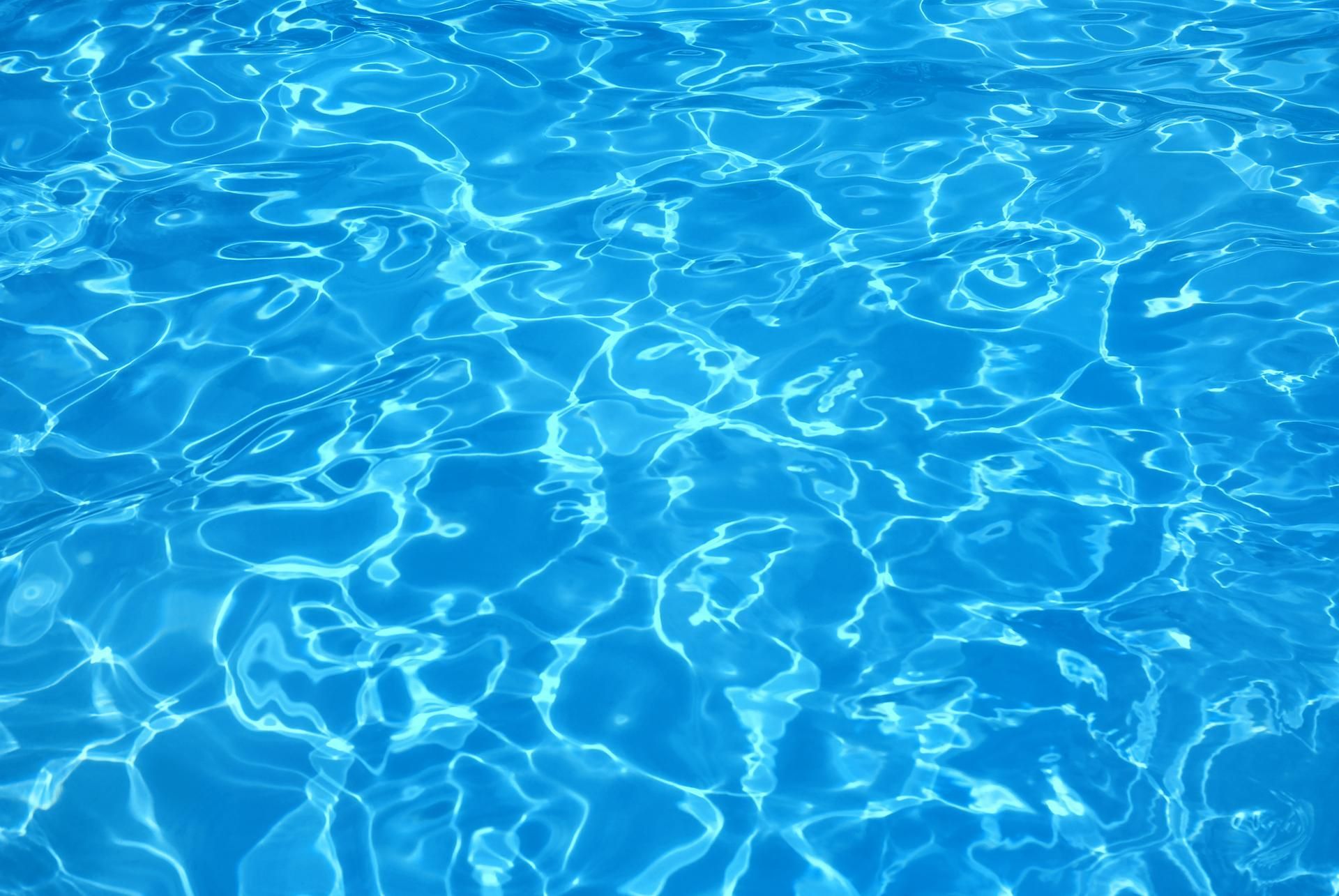 Blue pool water with shimmering light reflections.