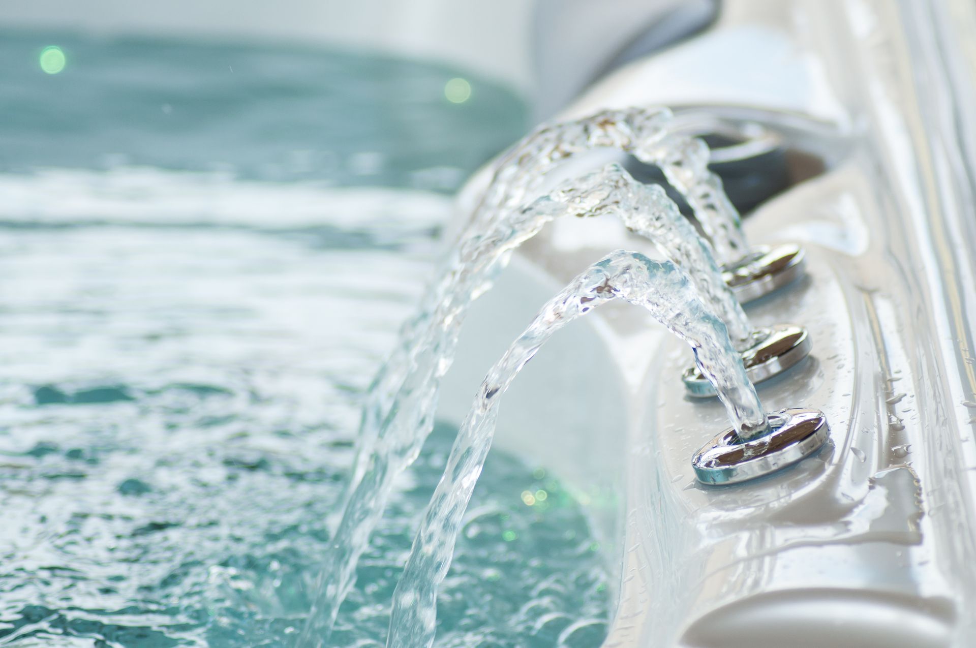 Close-up of water jets flowing into a hot tub, creating a relaxing bubbling effect. Close-up of water jets flowing into a hot tub, creating a relaxing bubbling effect.