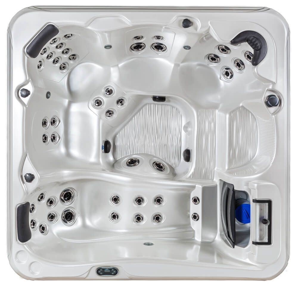 Top-down view of a white rectangular hot tub with molded seating, multiple jets, and two black headrests.