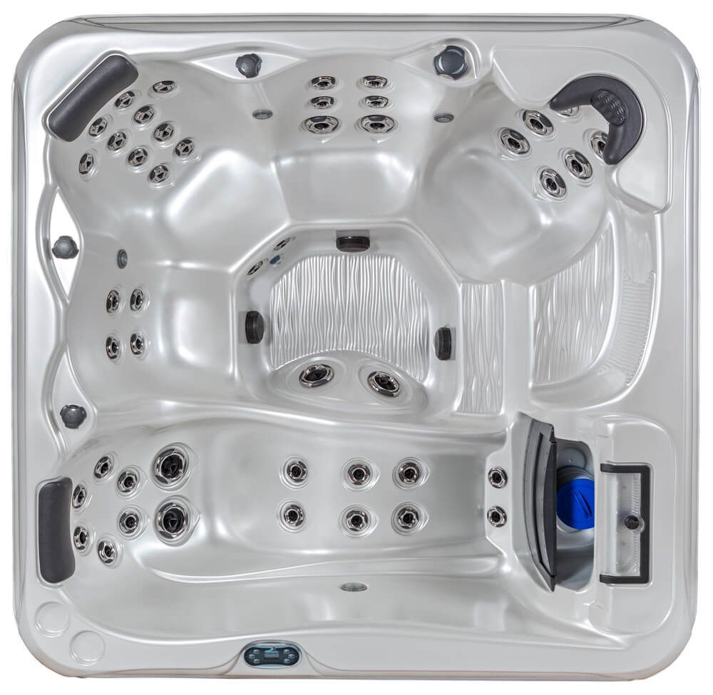 A top-down view of a rectangular, white acrylic hot tub with multiple seats, dark headrests, and integrated water jets.