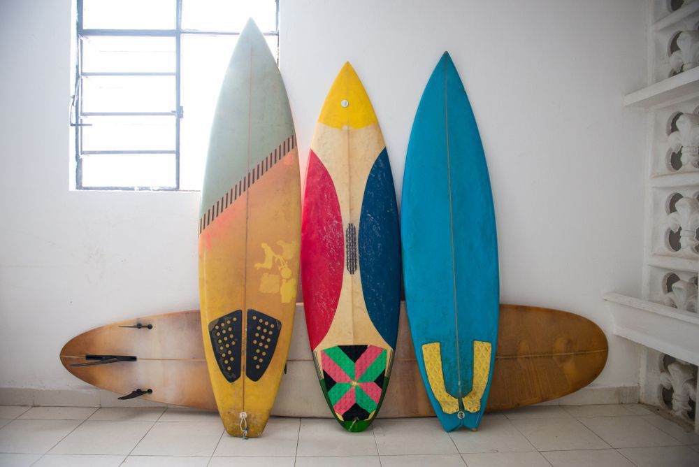 Multiple surfboards staying by the wall inside of the house — Bodyboards in Erina, NSW