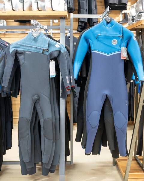 Wetsuits Hanging Up in the Surf Shop — Slimes Boardstore in Erina, NSW