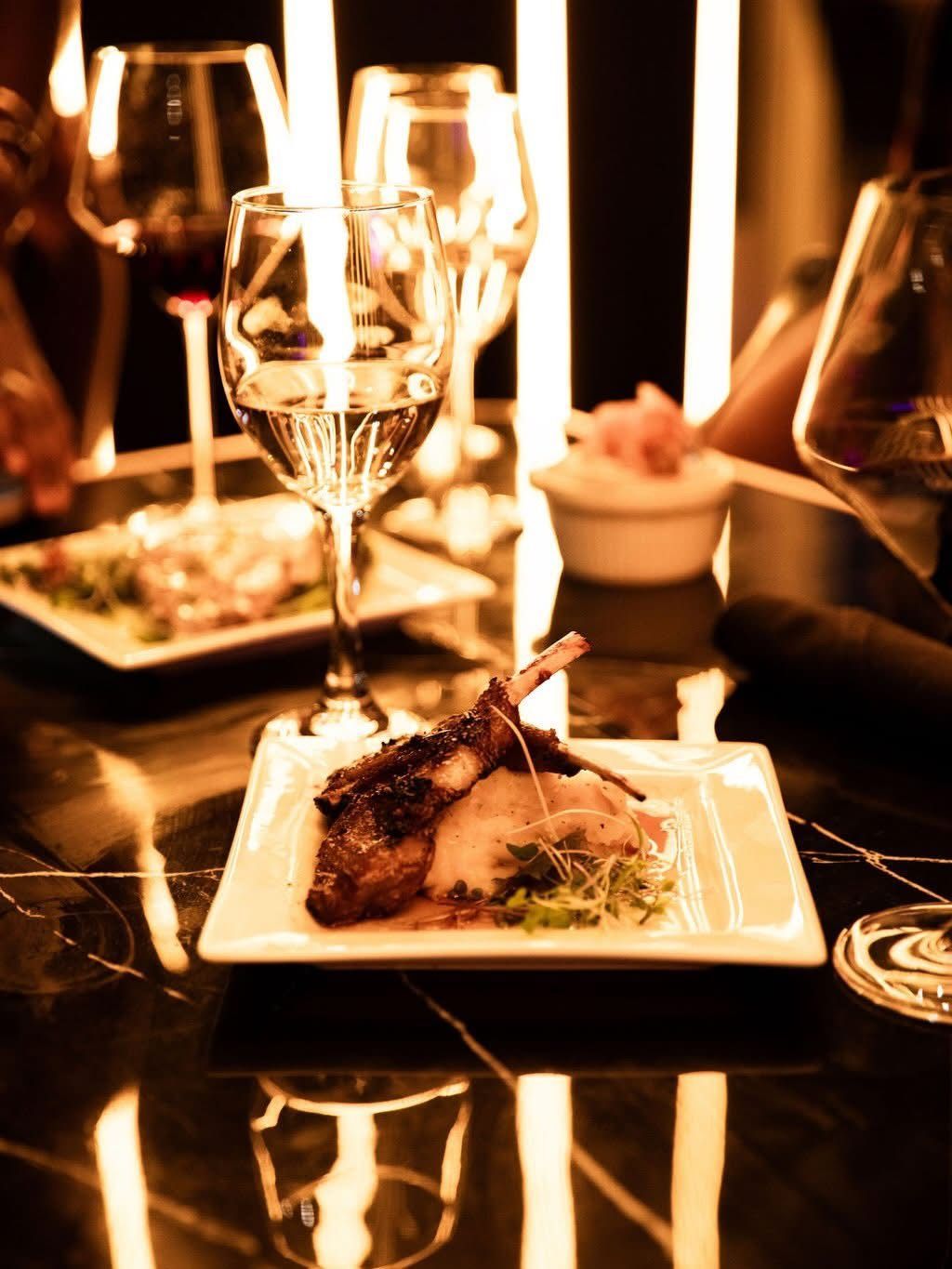 Plated dinner with warm table lighting
