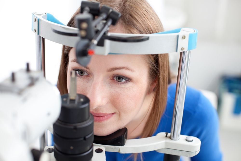 A Woman Is Getting Her Eyes Examined by An Ophthalmologist — John Williams Optometrist in Grafton, NSW