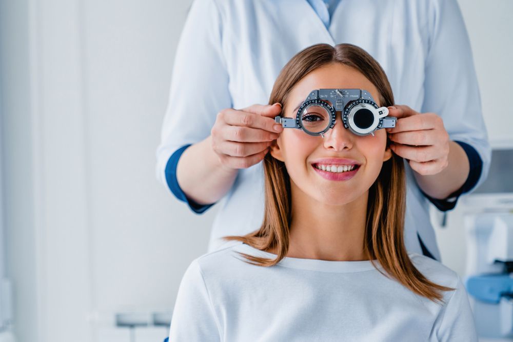 A Woman Is Getting Her Eyes Checked by An Ophthalmologist — John Williams Optometrist in Grafton, NSW