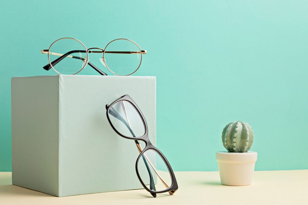 A Pair of Glasses Sitting on Top of A Box Next to A Cactus — John Williams Optometrist in Grafton, NSW