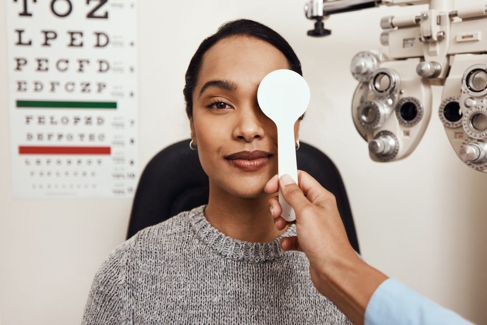 A Woman Is Getting Her Eyes Checked by An Ophthalmologist — John Williams Optometrist in Grafton, NSW