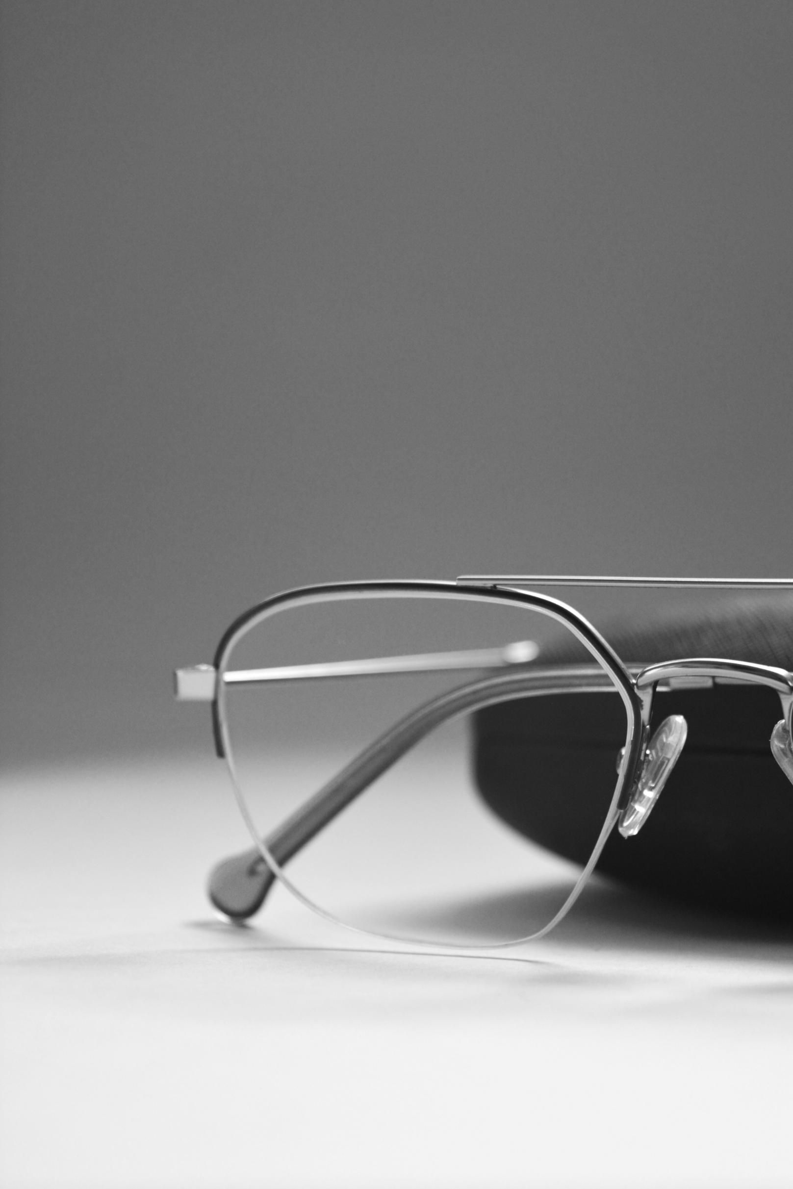 A Pair of Glasses Sitting on Top of A Case on A Table — John Williams Optometrist in Grafton, NSW