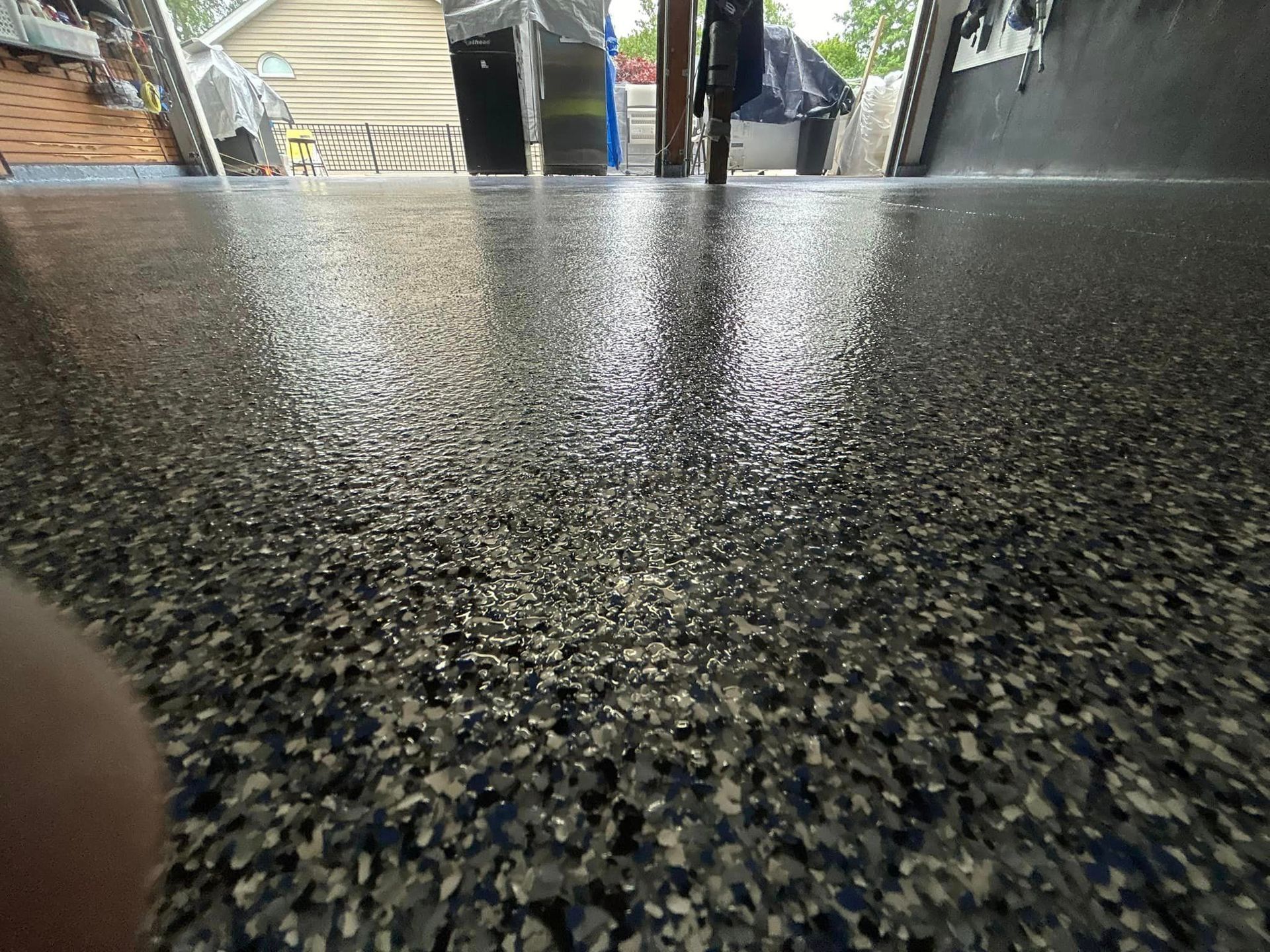A close up of a garage floor with a lot of small stones on it.