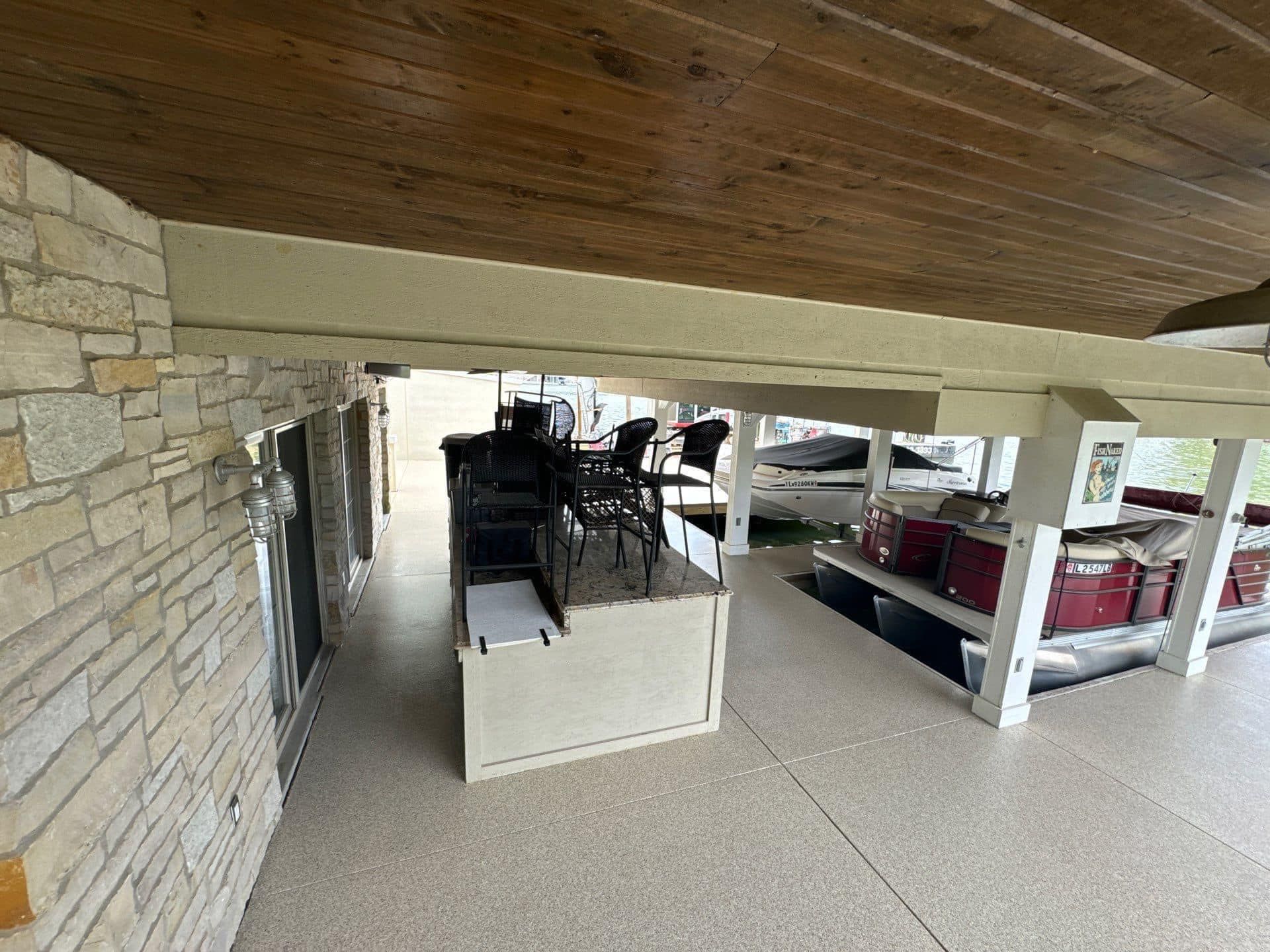 A large room with a lot of furniture and a boat in the background.