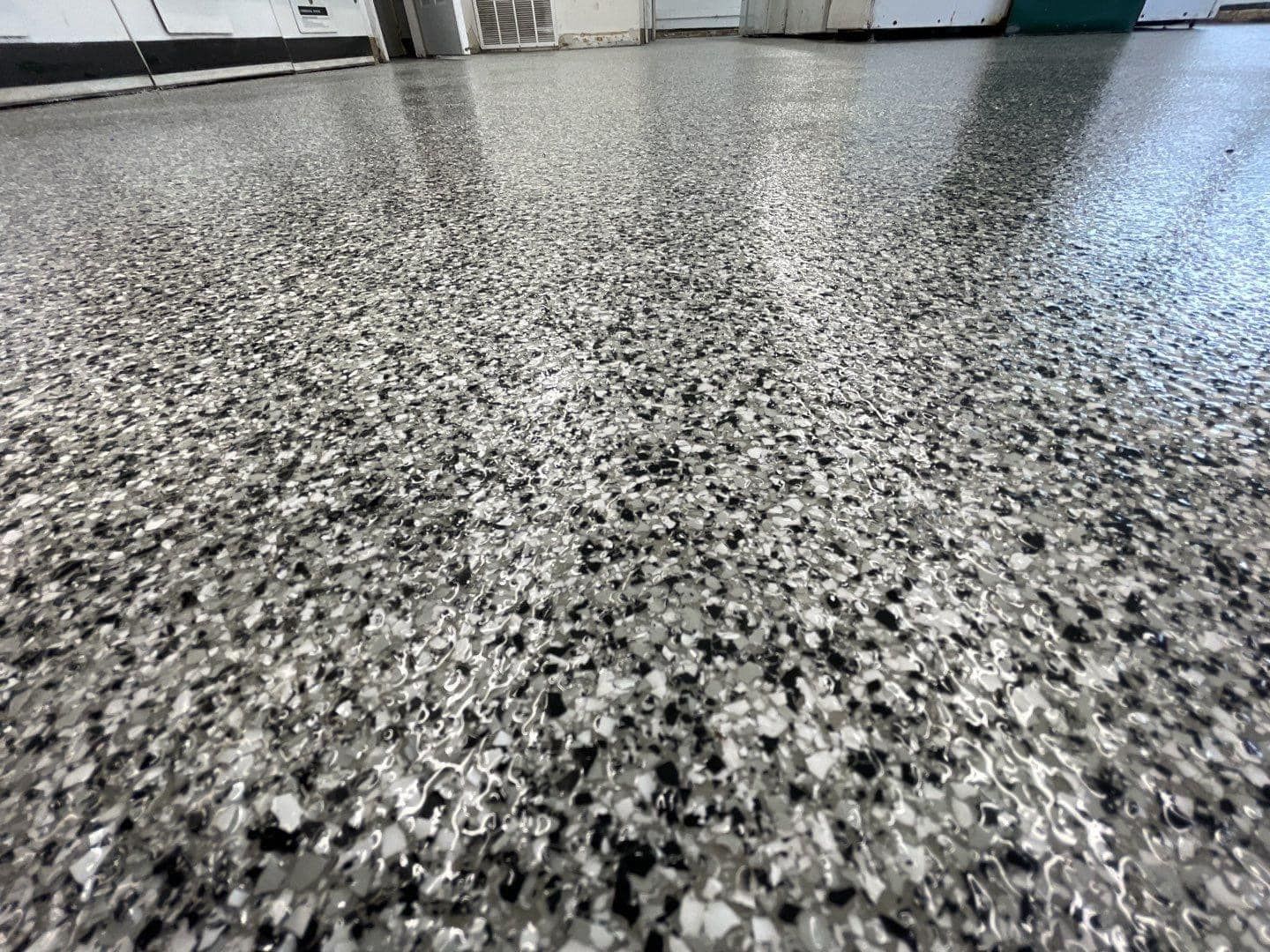 A close up of a gray and black floor in a garage.