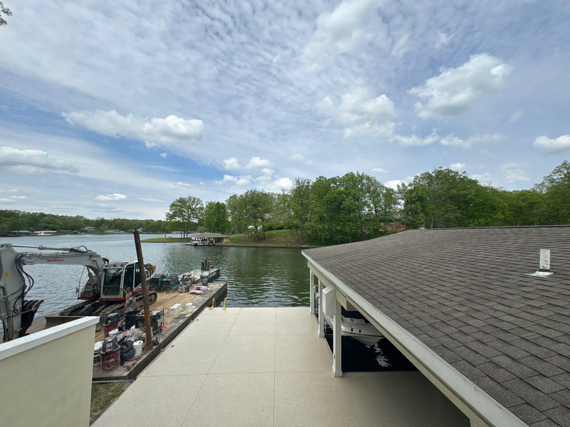 A boat is docked at a dock next to a lake