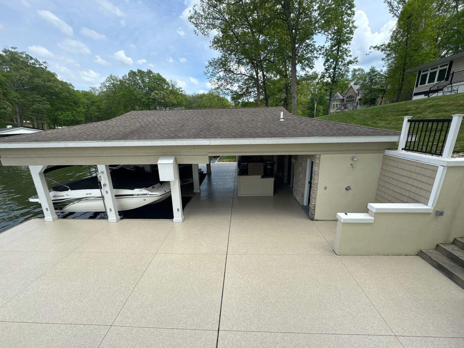 A boat is being lifted into a dock under a house.
