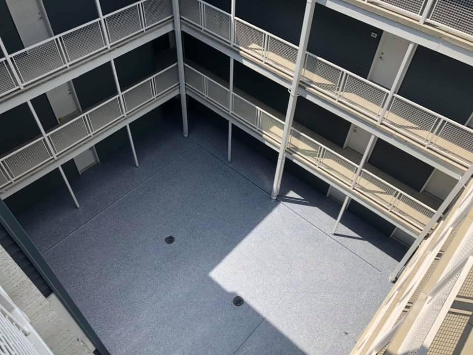 An aerial view of a building with balconies and stairs