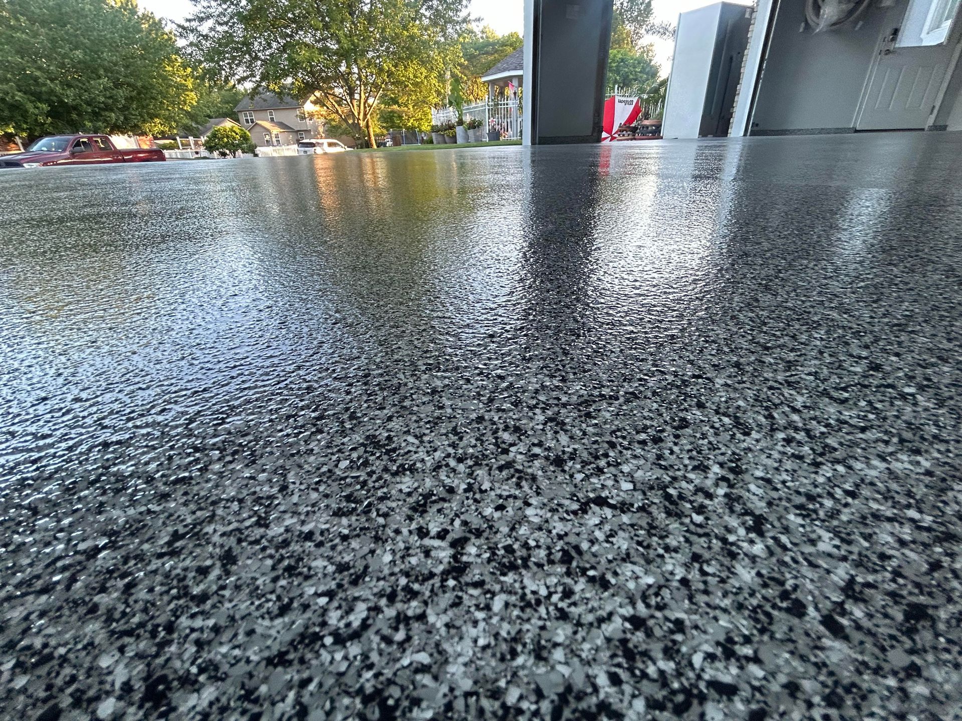 A close up of a garage floor with a lot of small rocks on it.
