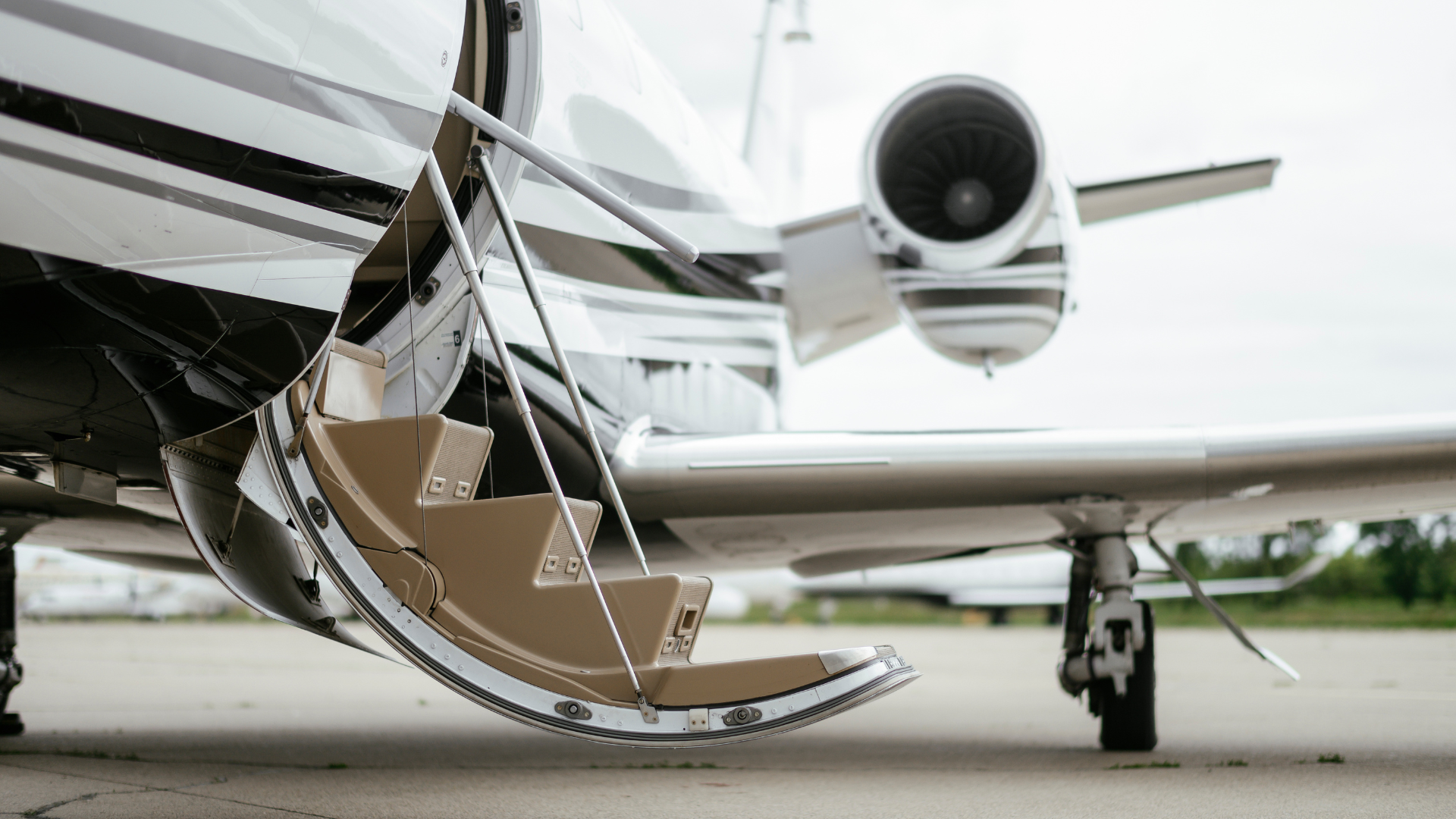 Open cargo door and a jet engine on a small private airplane on the tarmac