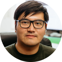 A man wearing glasses and a green shirt is in a circle