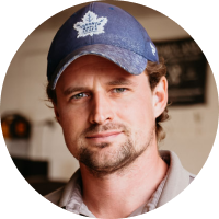 A man named Dave wearing a blue hat with a maple leaf on it