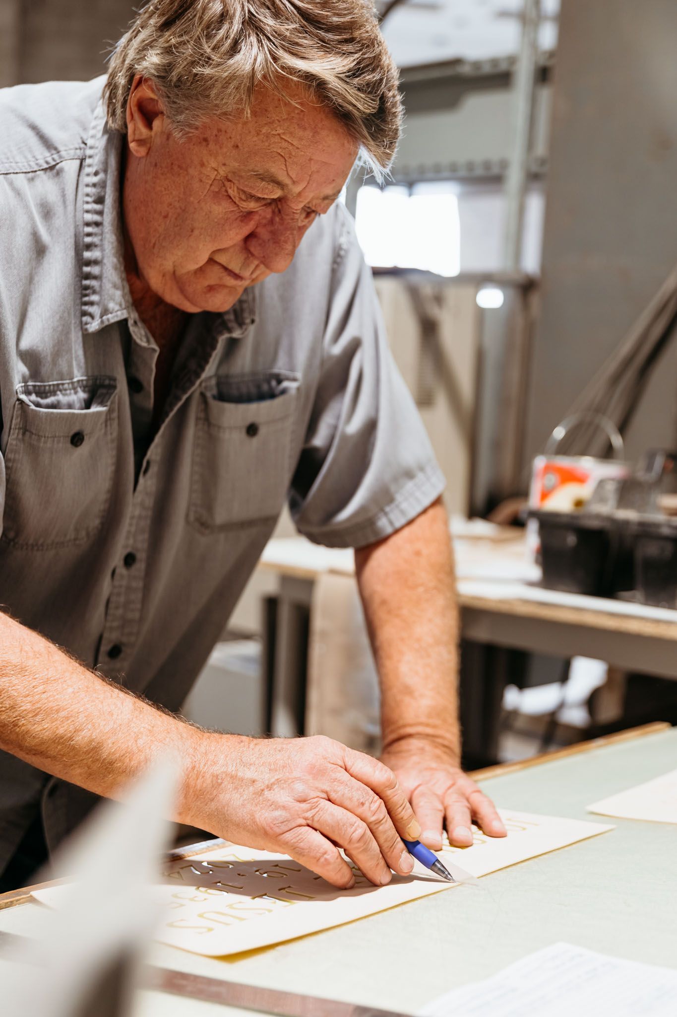 A close up of a person 's hand carving the word jason