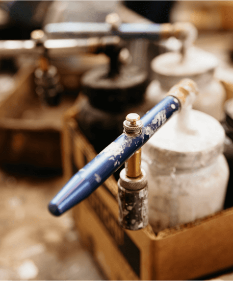 A close up of a faucet with a blue handle