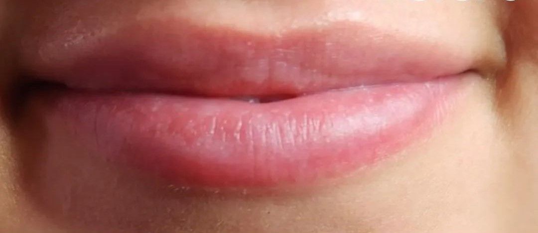 Close-up of human lips, pink and slightly parted.