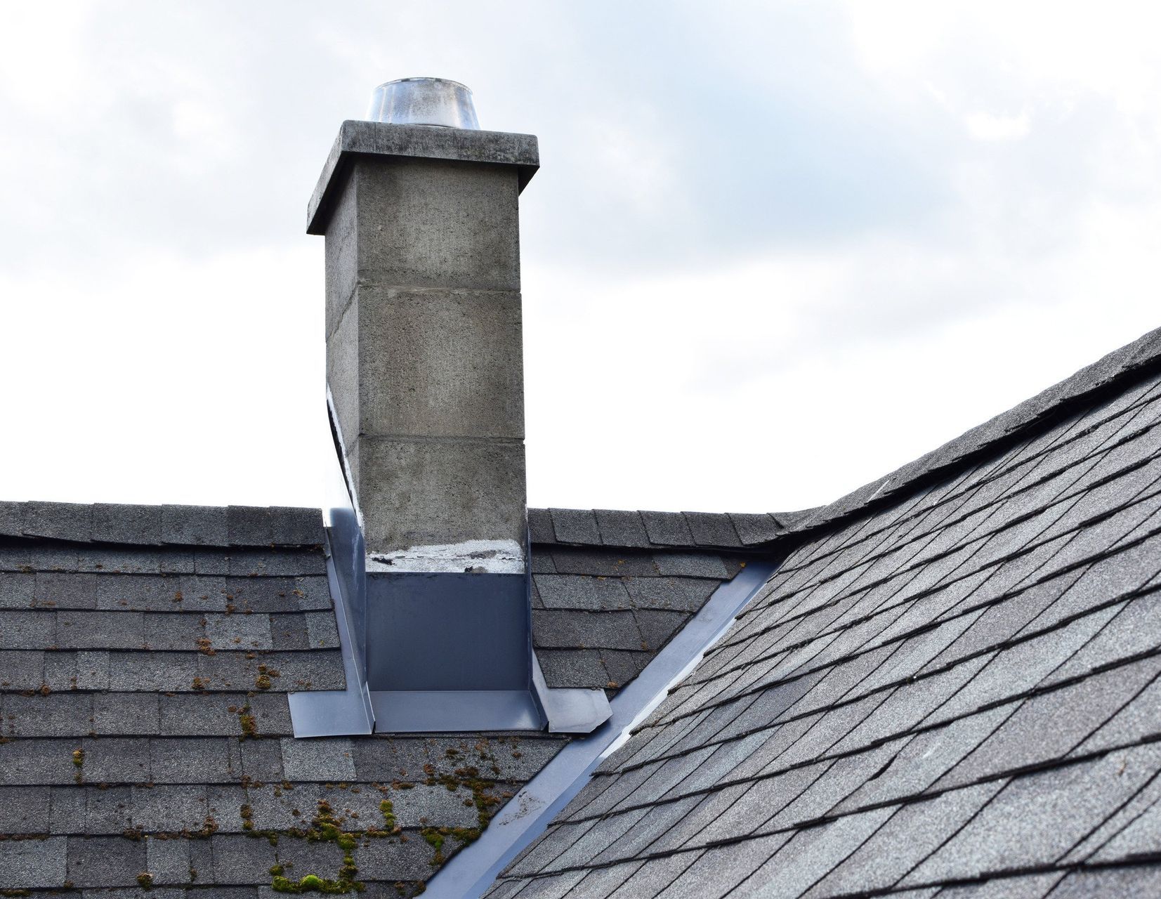 A chimney is sitting on top of a roof.