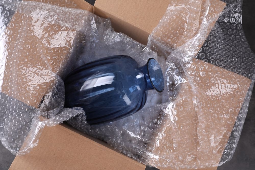 Blue glass vase packed in a cardboard box with bubble wrap for shipping — Nelson Bay Self Storage in Salamander Bay, NSW