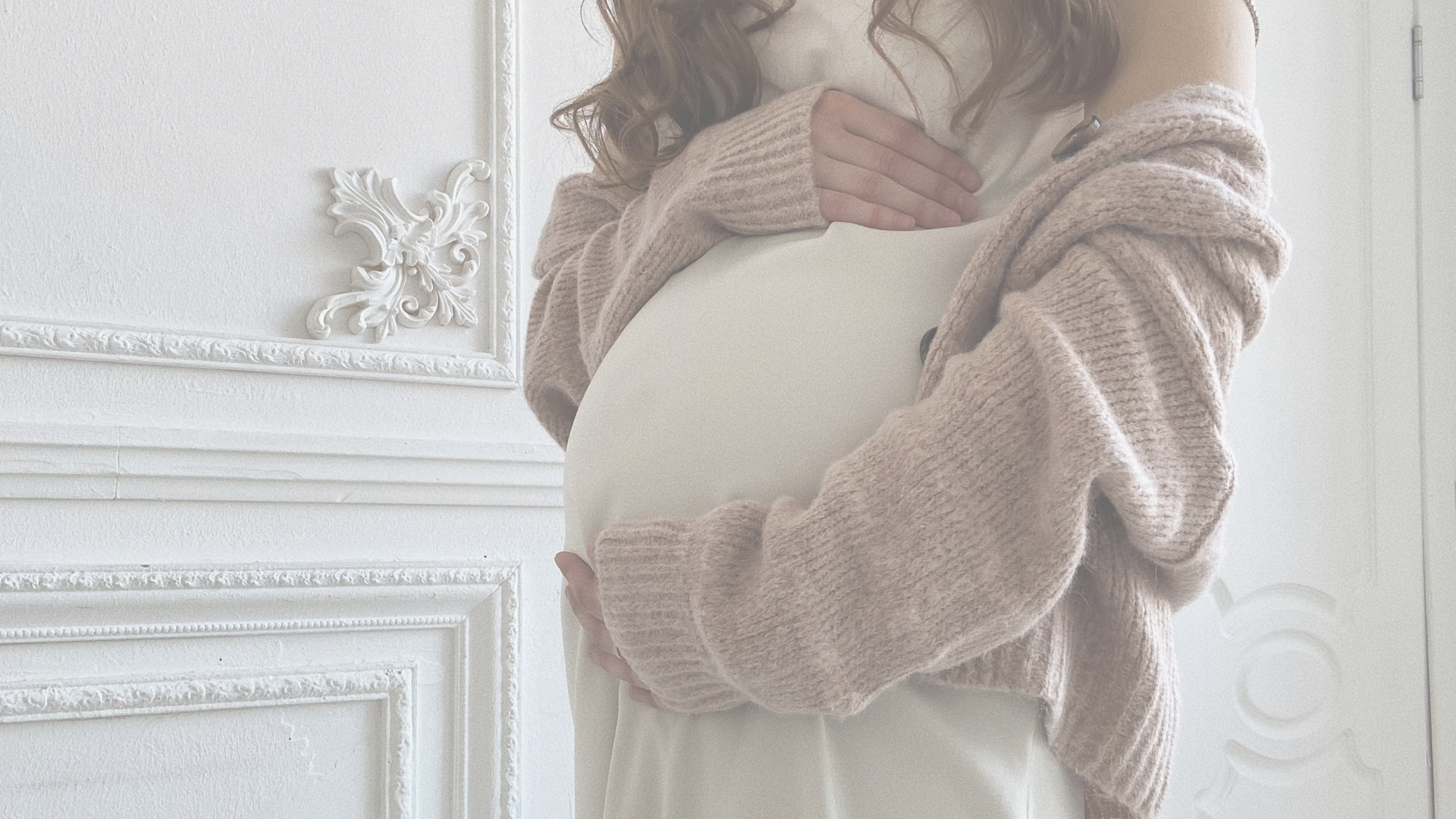 questions to ask your provider when you want a natural birth: woman holding her pregnant belly