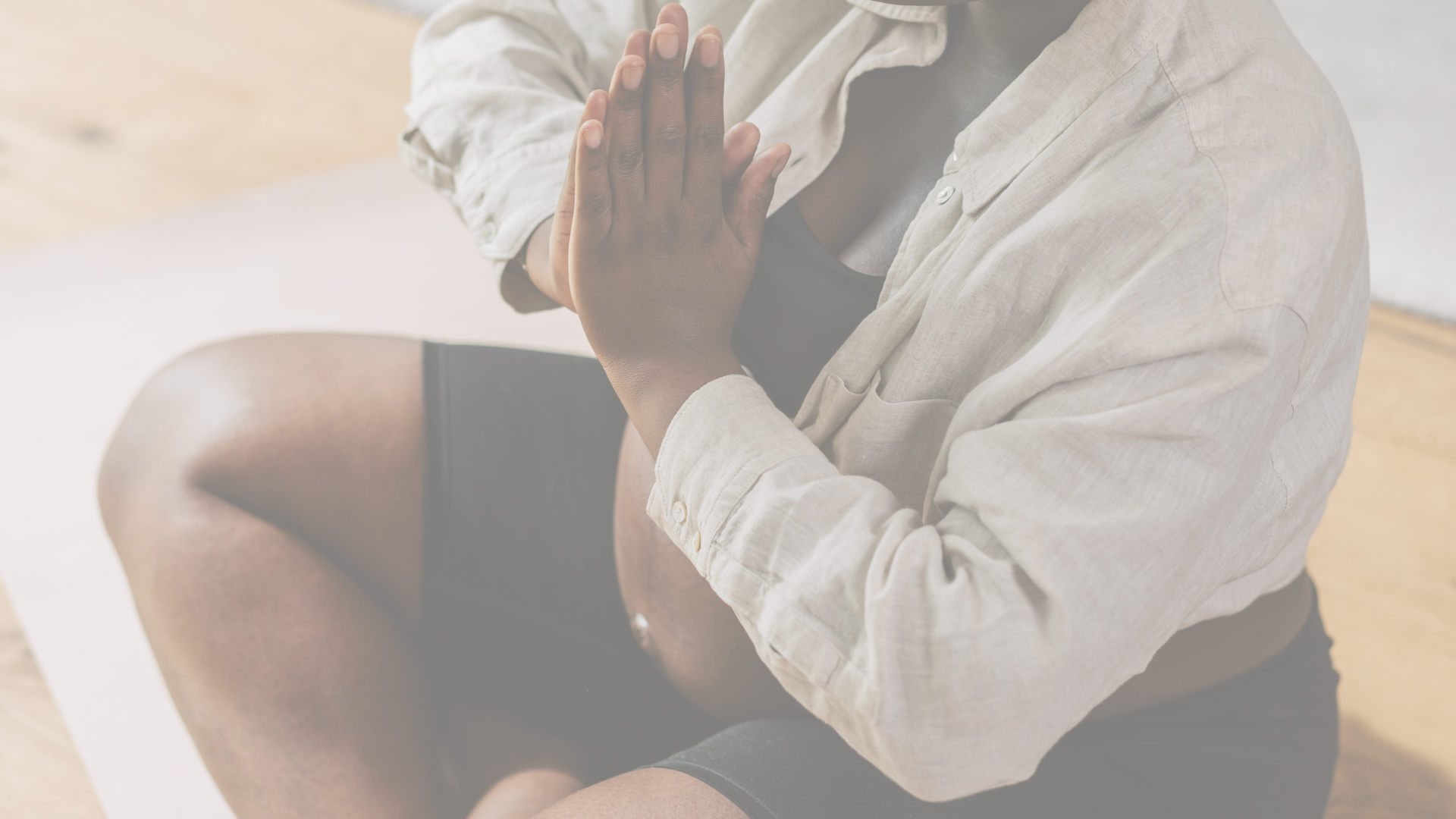 Pregnant woman in a seated position practicing mindfulness in prenatal yoga
