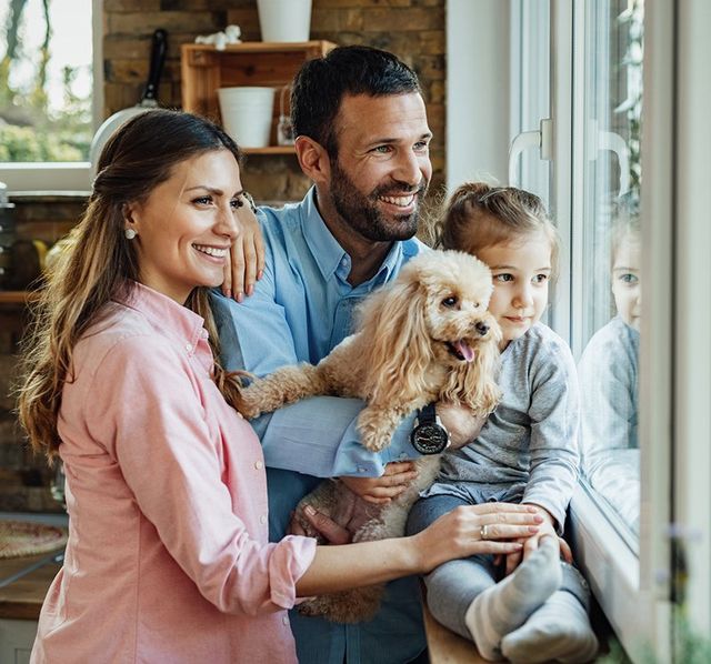 Family with a Dog Looking at the Window — North Charleston, SC — The Bridge Benefit Group