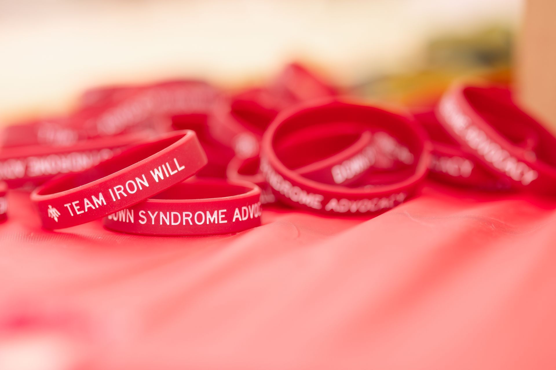 Red wristbands with white text, including