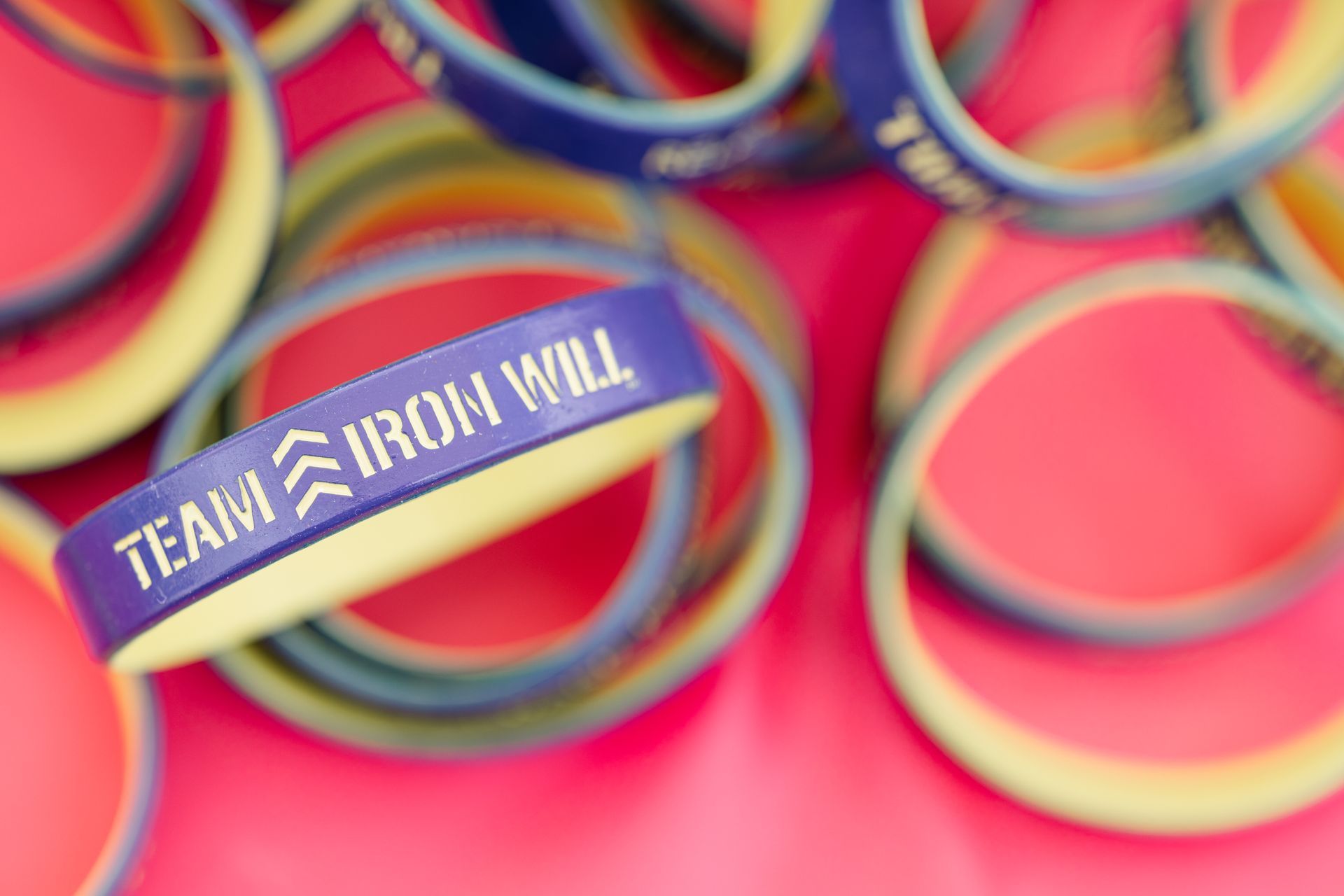 Pile of blue and yellow rubber bracelets with