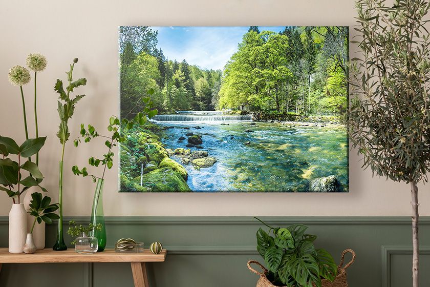 Canvas print on a wall with two people walking on the beach at sunset