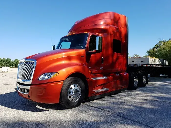 Mid-century modern credenza with a lamp and decorative objects, in a sunlit room.