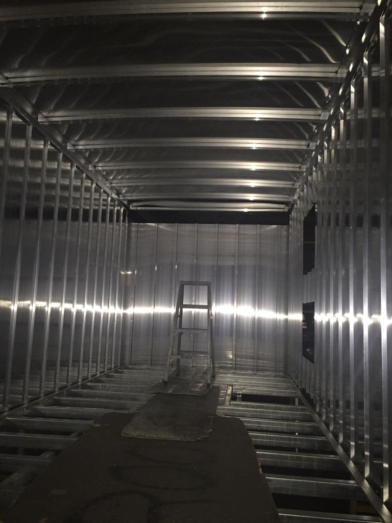 The inside of a building with a ladder in the middle