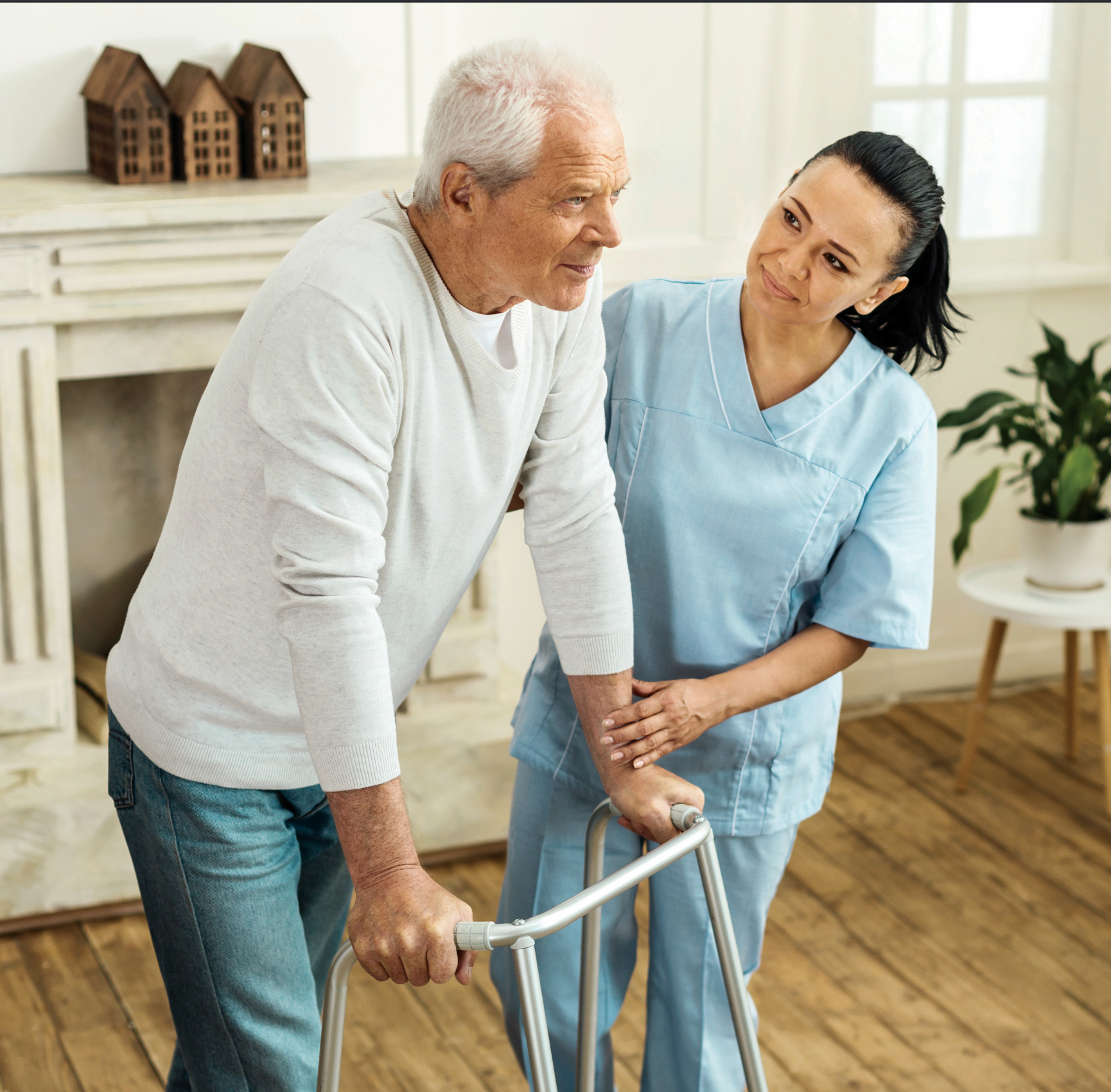 A woman is helping an elderly man with a walker
