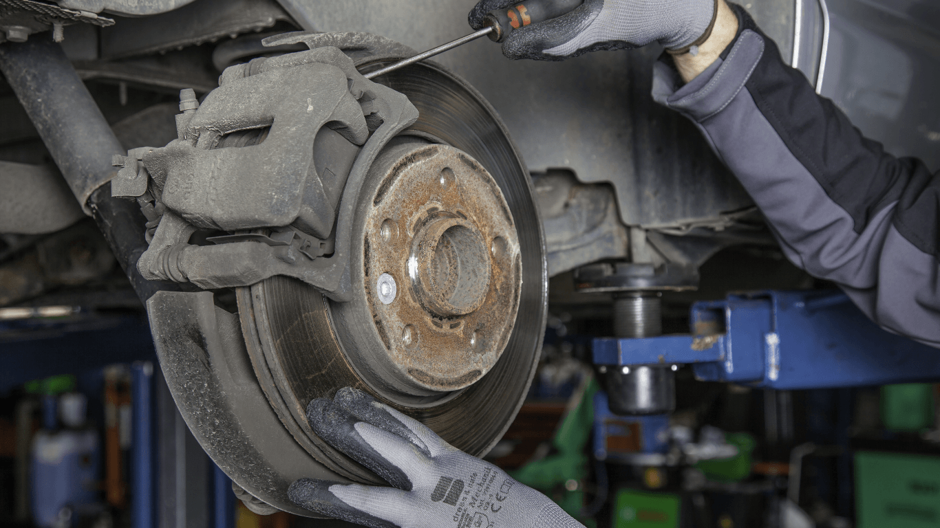 a mechanic repairing brakes
