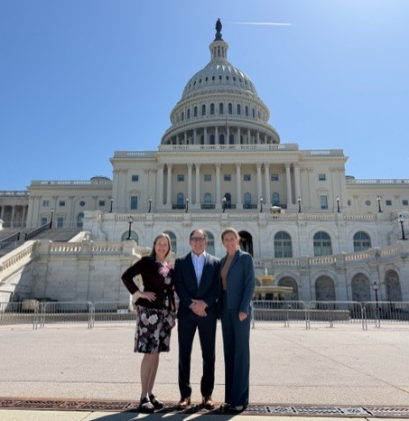 Advocates posing outside the White House