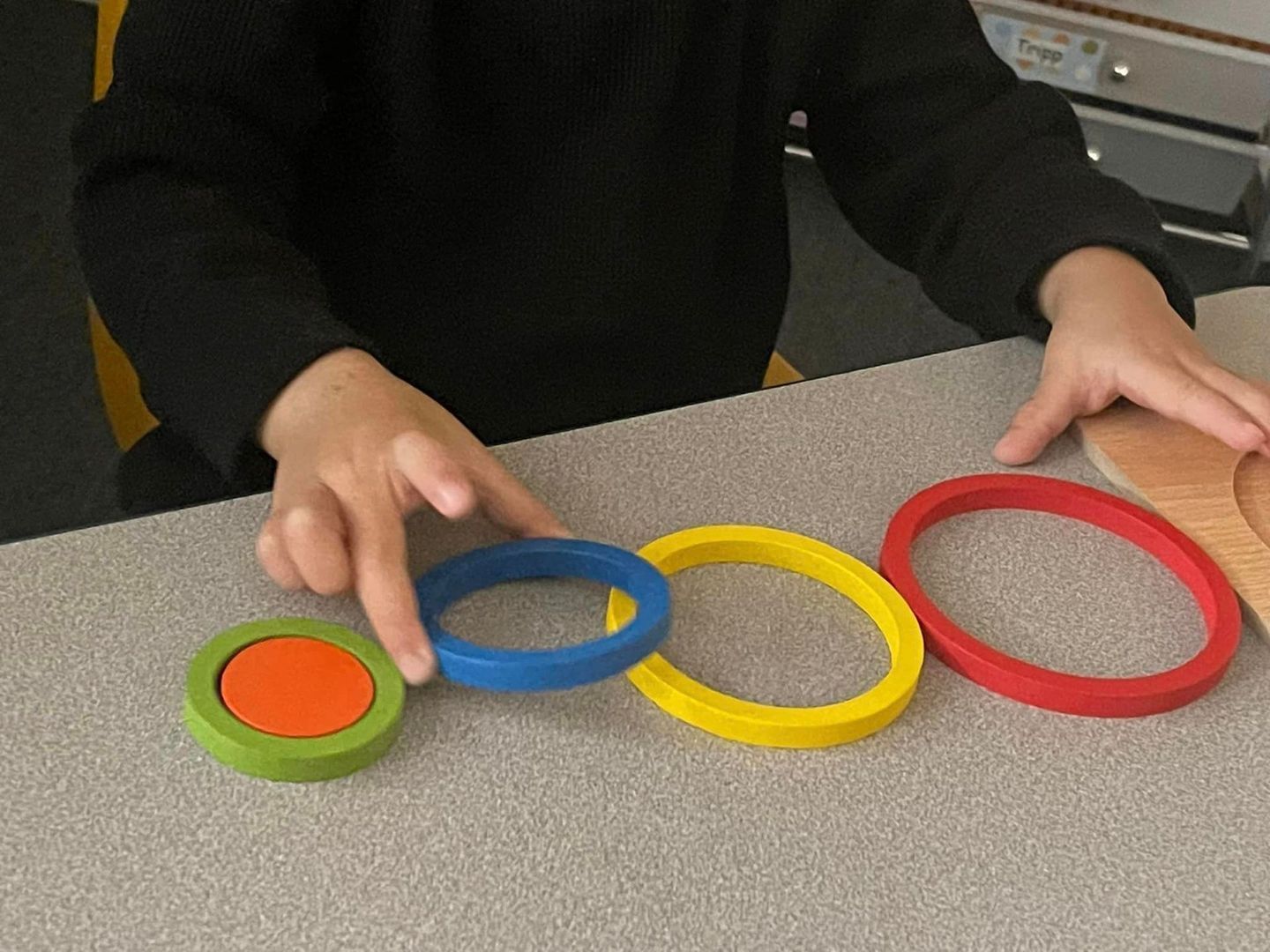 Child's hands playing with wooden toys