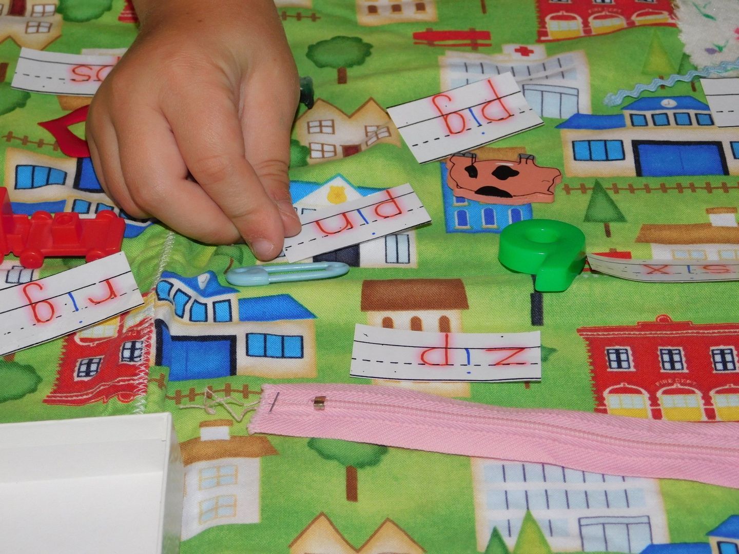 Child's hand placing a word card 