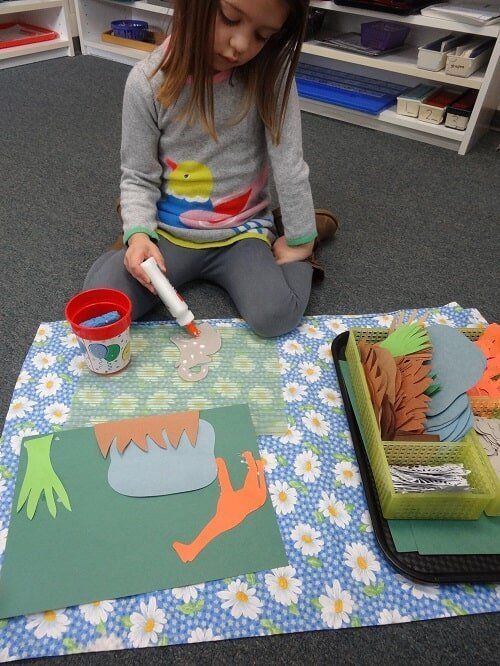 Girl seated, working on a craft