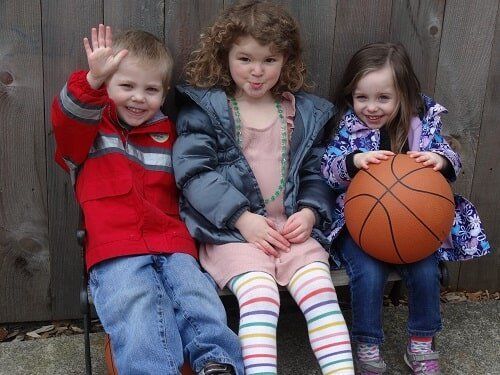 Three children sitting on a bench