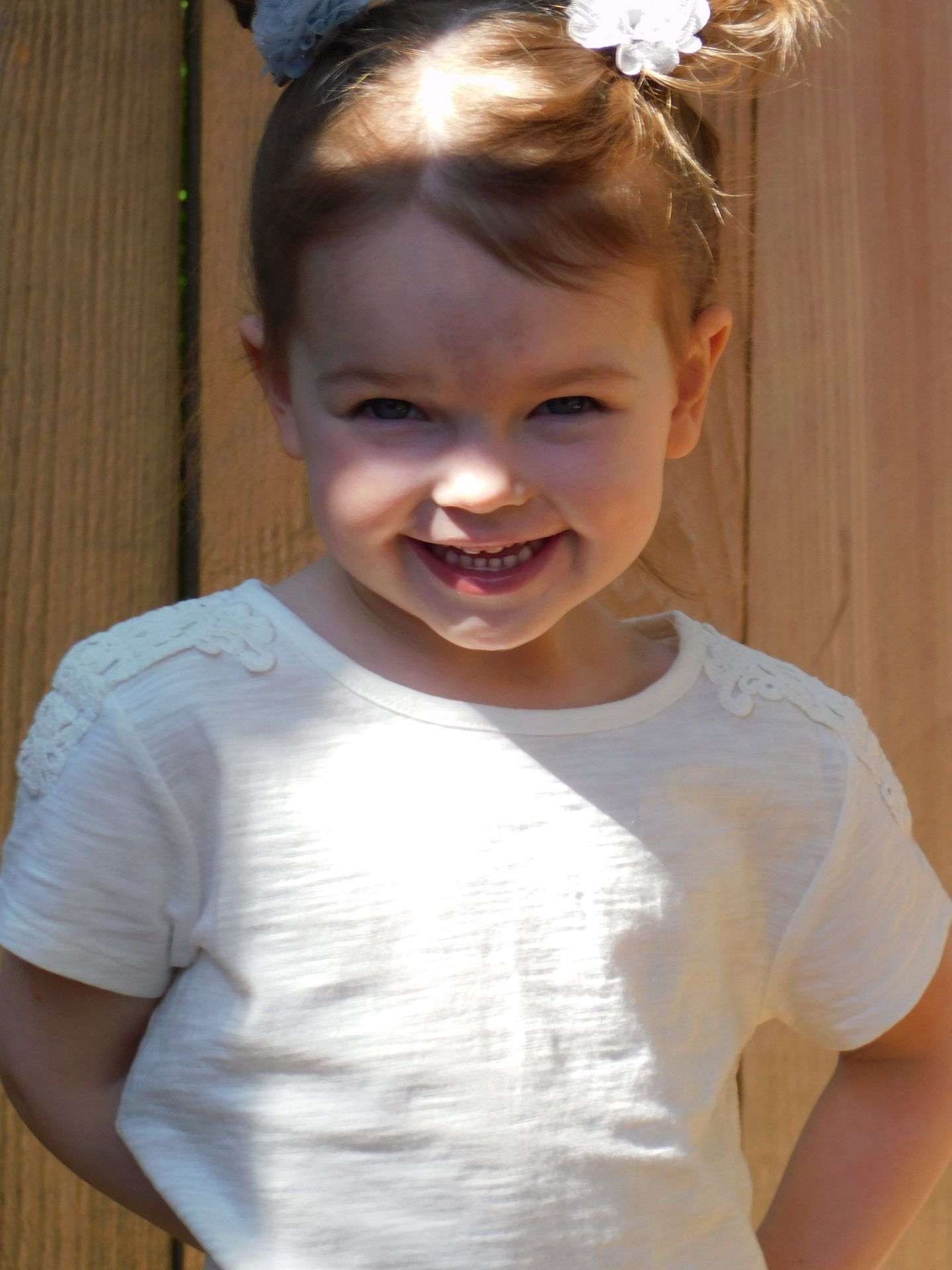 Smiling young girl with light hair pulled up
