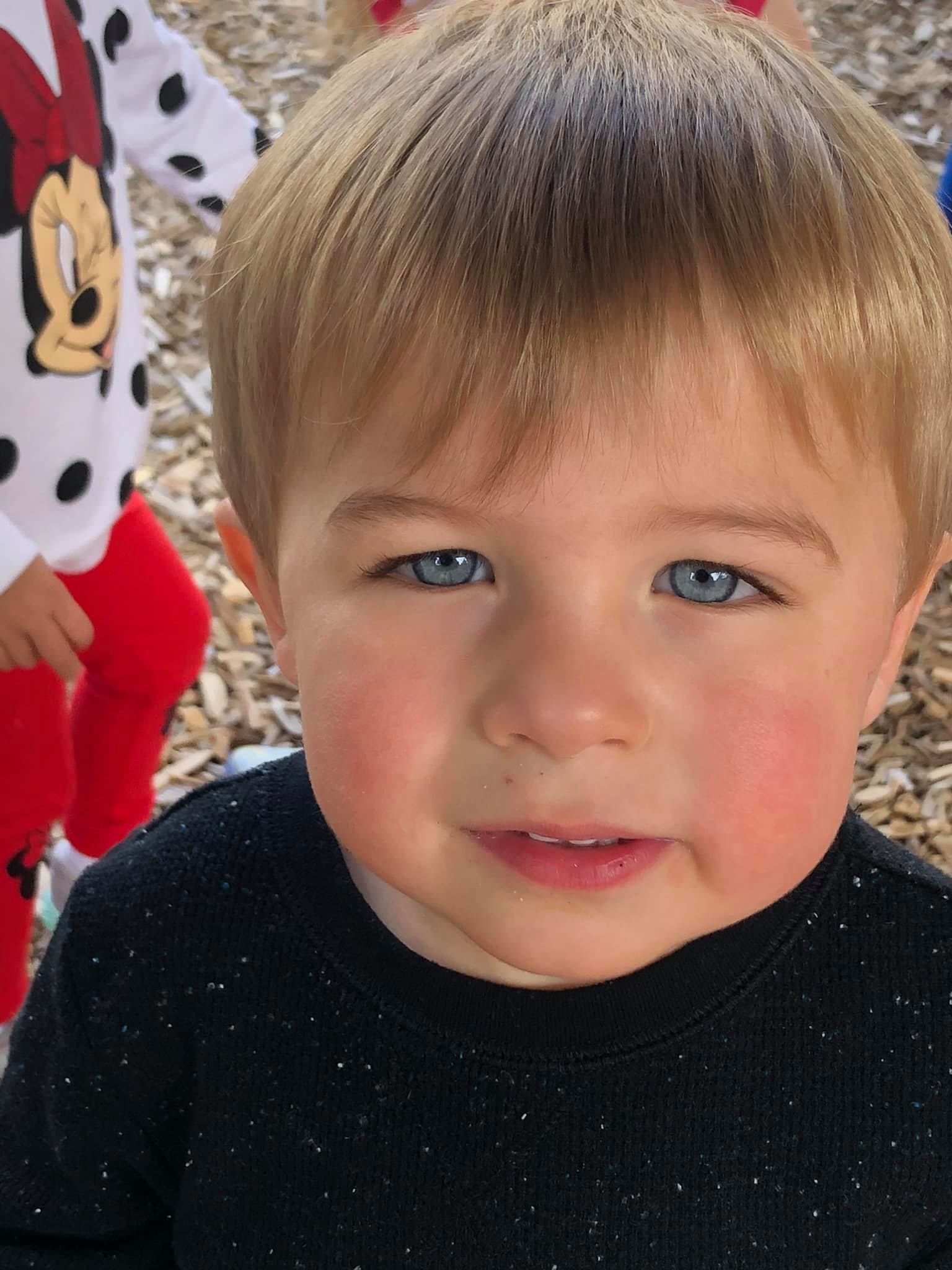A young boy with blonde hair and blue eyes