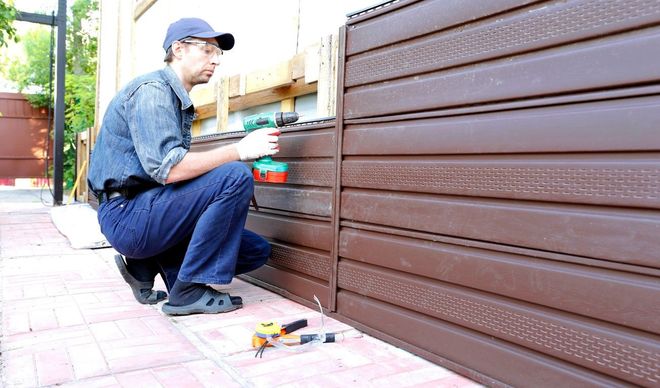 person installing metal siding